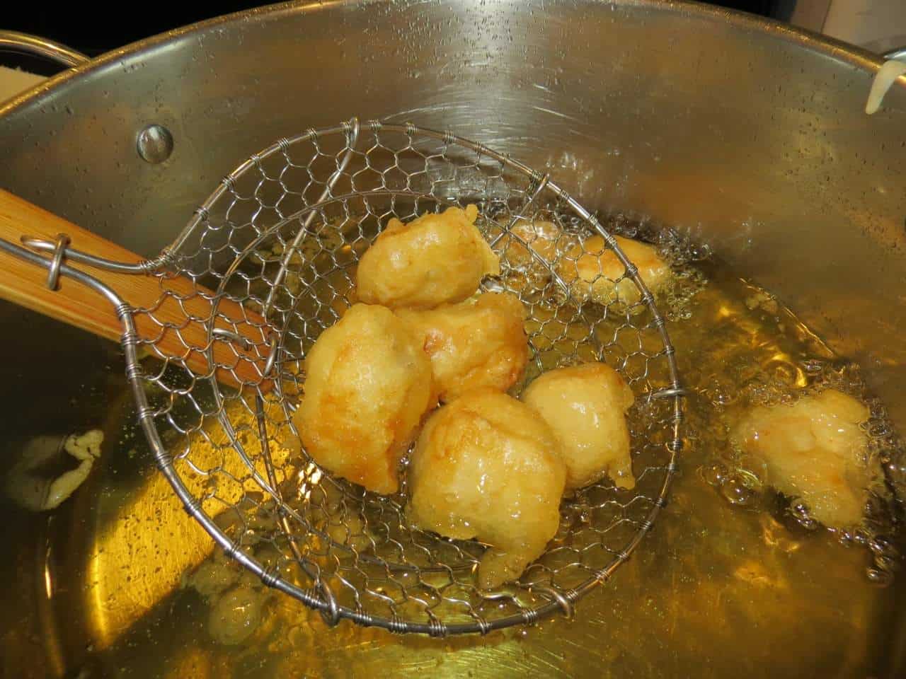 Whiskey Glazed Chicken Nuggets are lightly fried then tossed in our addicting whiskey glaze! Serve this chicken nugget recipe for appetizers or dinner! Chicken nuggets frying in oil