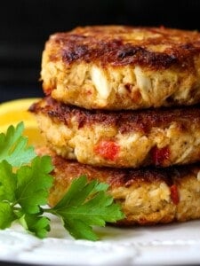 crab cakes stacked on a white plate