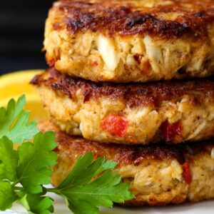 crab cakes stacked on a white plate