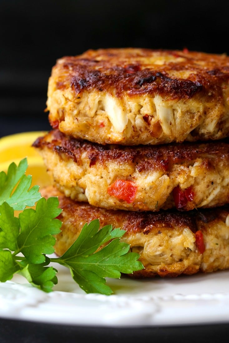 crab cakes stacked on a white plate