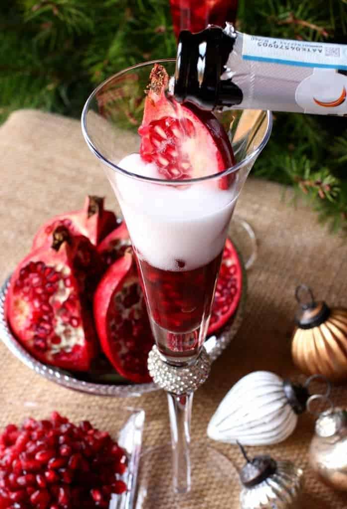 A Prosecco Holiday Pom Pom is a champagne drink recipe that has fresh pomegranate seeds