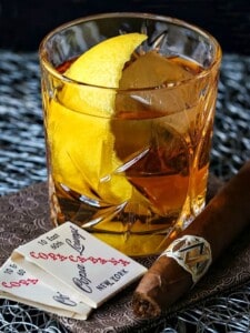 The Godfather Cocktail is a bourbon or whiskey drink with a lemon twit