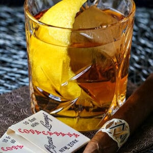 The Godfather Cocktail is a bourbon or whiskey drink with a lemon twit