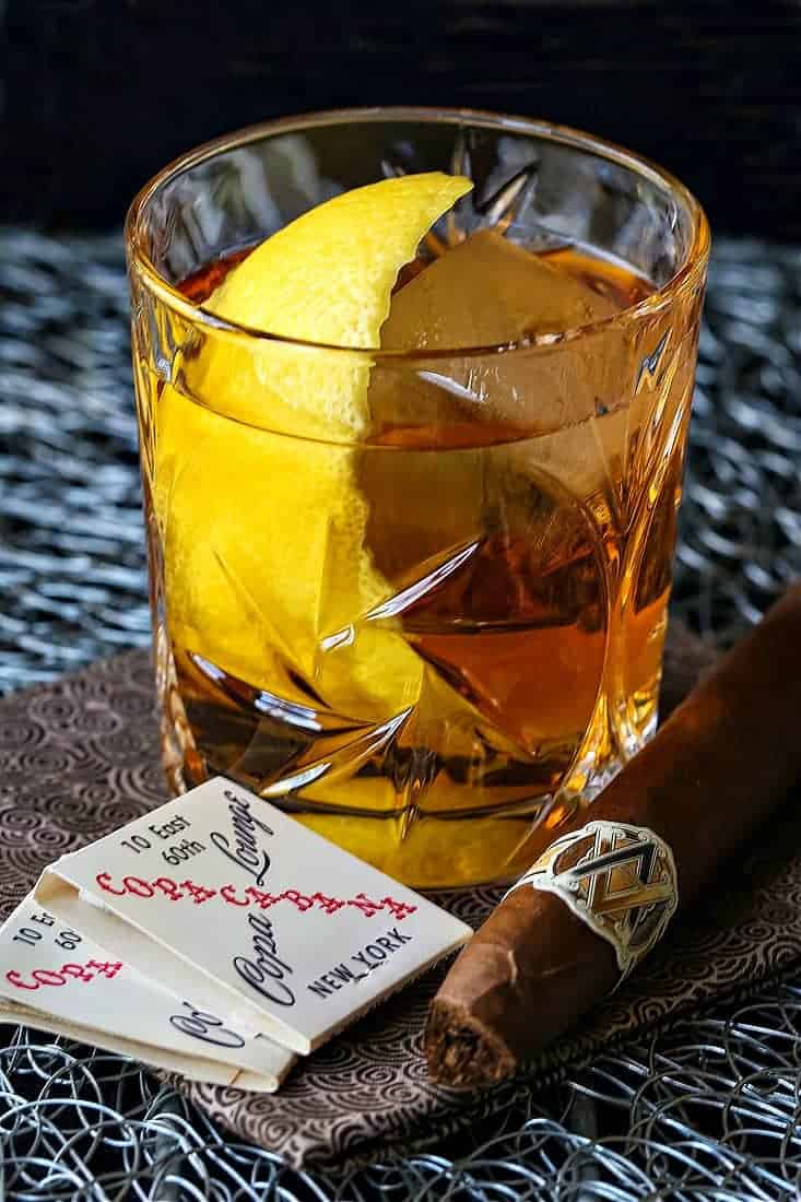 The Godfather Cocktail is a bourbon or whiskey drink with a lemon twit