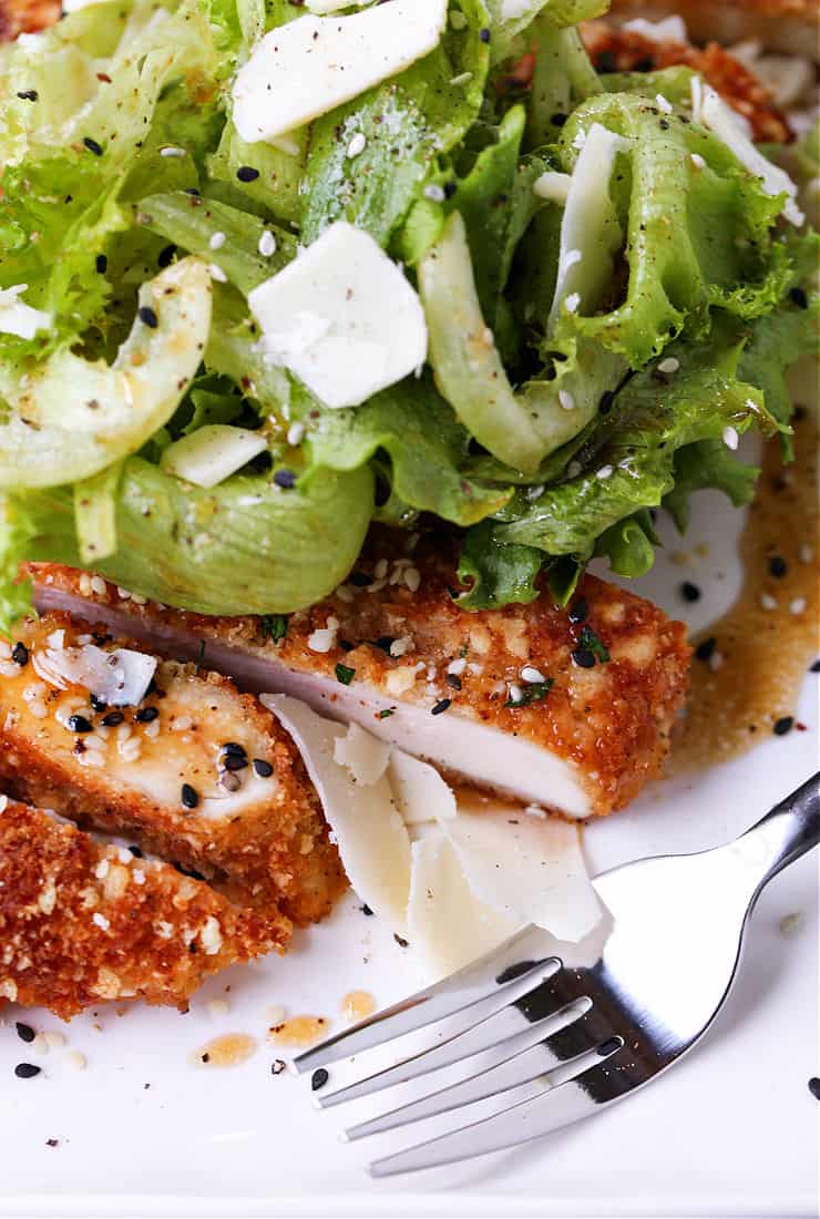 Sesame Chicken Milanese is a delicious twist on the classic chicken recipe! Thin, crispy chicken cutlets topped with crisp greens and an Asian vinaigrette! chicken milanese recipe with sesame flavors