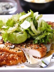 Sesame Chicken Milanese on a white plate with fork