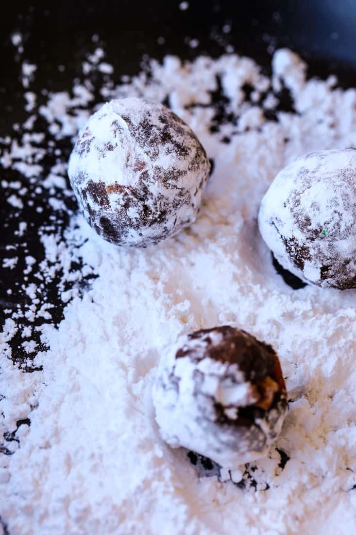 Chocolate bourbon balls in powdered sugar