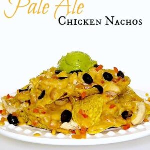 nachos on a whit plate with beer flavored cheese sauce