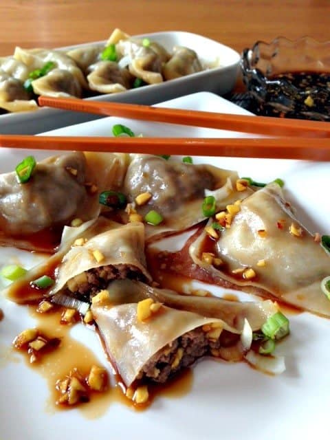 Pork and Ginger Pot Stickers on a plate with sauce