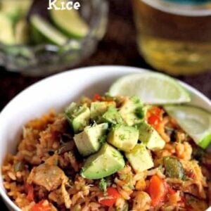 Chicken Fajita Rice in a bowl with limes and beer