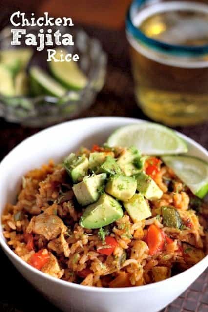 Chicken Fajita Rice in a bowl with limes and beer