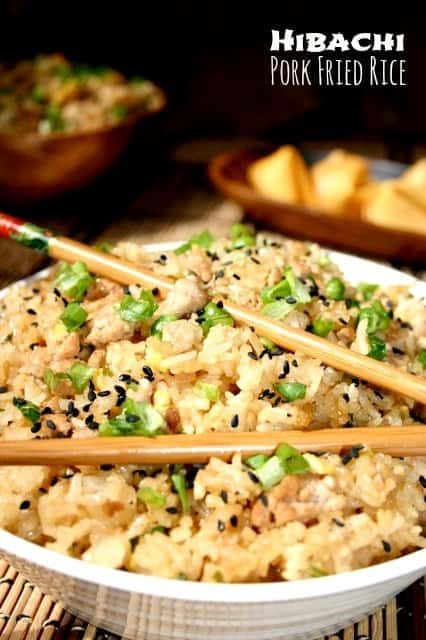 This delicious Hibachi Fried Rice recipe has sweet pineapple flavors with soy and ginger tossed with sticky rice and lean ground pork! hibachi fried Rice in a bowl with chop sticks