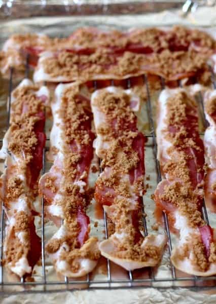 Deviled Eggs with Candied Bacon are the perfect party food! Serve for brunch, appetizers or just for snacking! bacon slices cooking with brown sugar