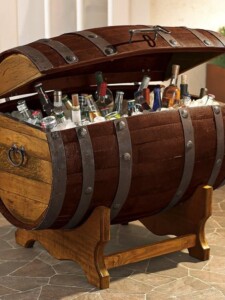 A barrel-shaped ice chest full of different kinds of tequila.