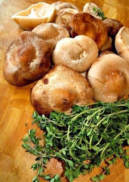 These Fried Shiitake Mushrooms are so perfectly delicious and crispy. Super tender and juicy mushrooms coated in a light, crispy beer batter! mushrooms on a board for Fried Shiitake Mushrooms