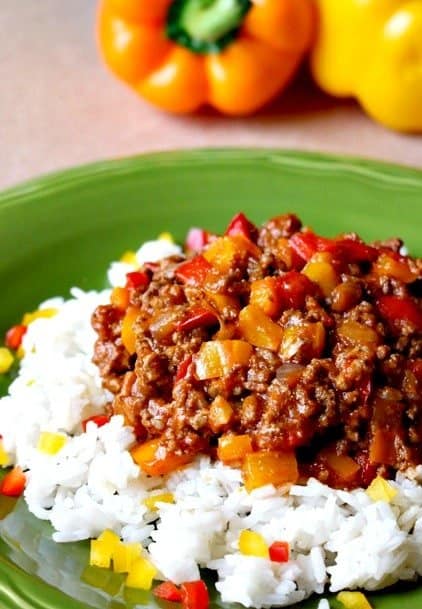Try Unstuffed Peppers for an easy dinner! Our kids actually EAT the peppers when we cut them up and mix them in with the ground beef! Unstuffed Peppers on a green plate over rice