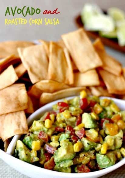 Avocado and Roasted Corn Dip in a white bowl with chips