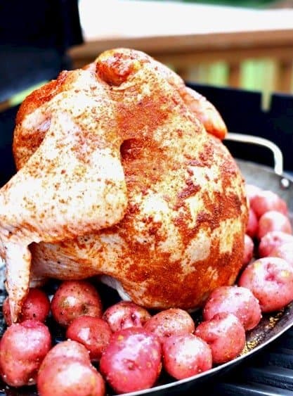 beer can chicken on the grill with potatoes