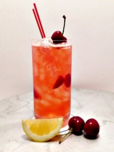 cherry lemonade in glass with straws