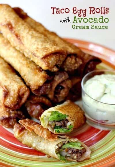taco egg rolls with avocado cream sauce on a plate