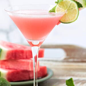 watermelon cosmopolitan in martini glass with garnish