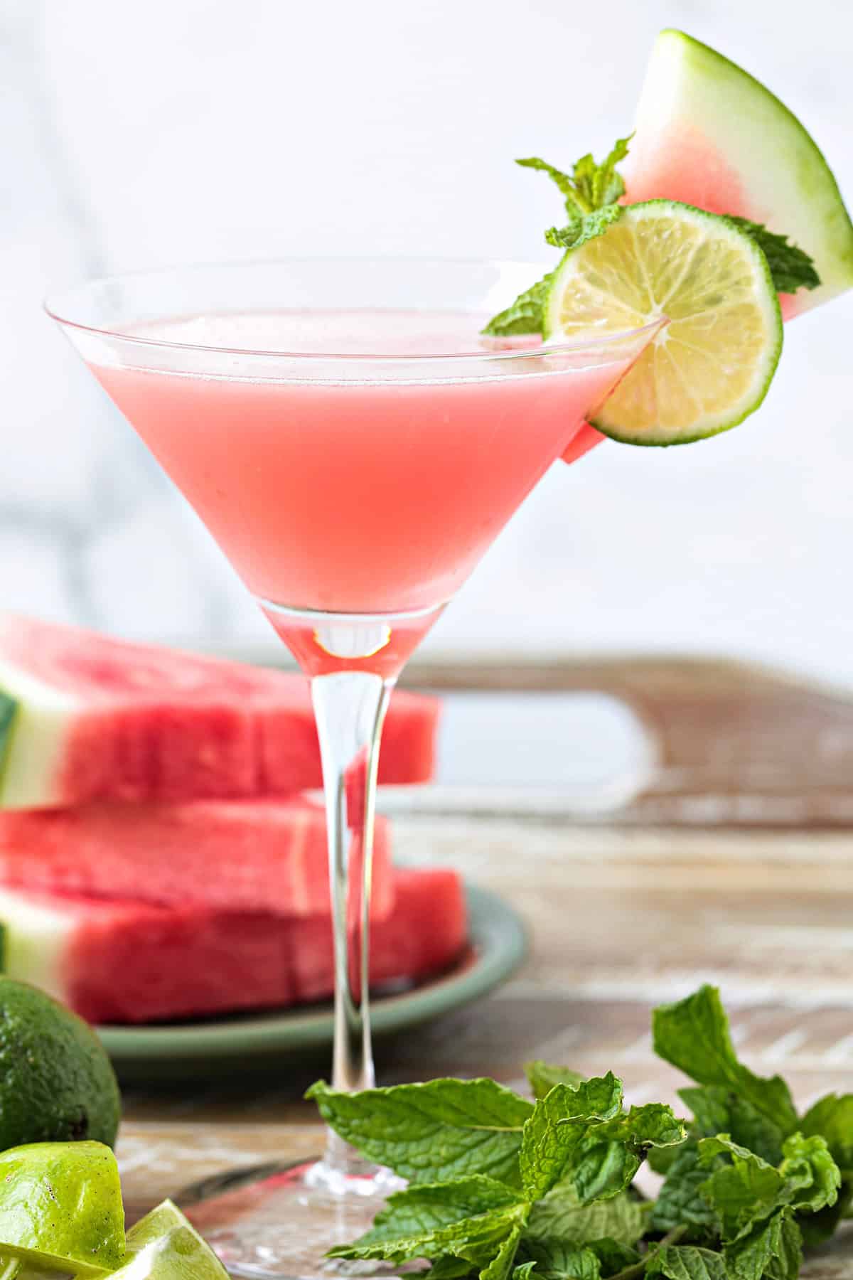 This Watermelon Cosmopolitan is the ultimate summer drink! So light and refreshing, made with fresh watermelon juice and a hint of lime! watermelon cosmopolitan in martini glass with garnish