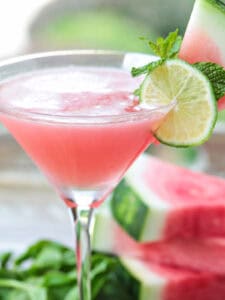 watermelon cosmopolitan with sliced watermelon in background
