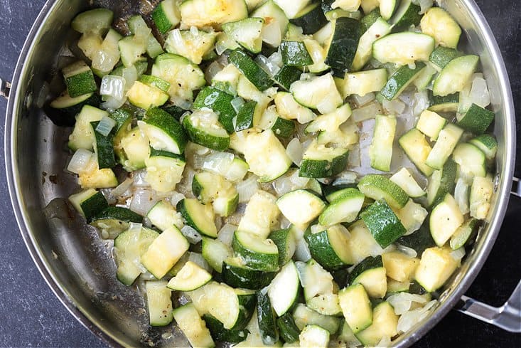 zucchini and onion in a skillet for making pasta sauce