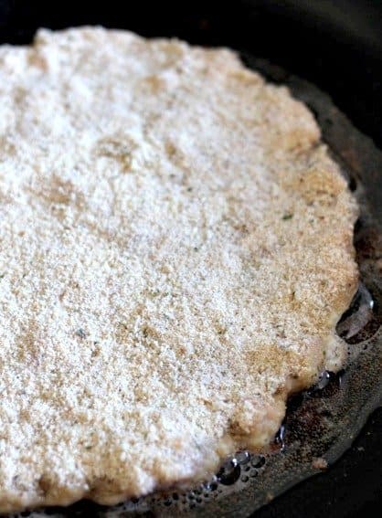 chicken parm pizza in pan frying before filpping