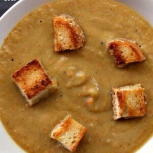 zucchini soup in a bowl with croutons