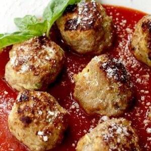 turkey meatballs made with zucchini on a plate with sauce