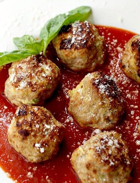 Meatballs in a red sauce with basil 