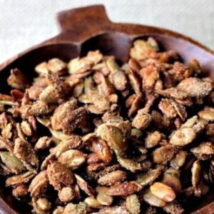 glazed pumpkin seeds in a pumpkin bowl