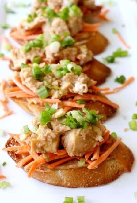 chicken satay bruschetta on a platter for serving