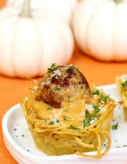 Spaghetti and Meatball Cups with Pumpkin Sauce are super fun for the holidays! We love serving these for Thanksgiving appetizers! Spaghetti and Meatball Cups with Pumpkin Sauce on a platter
