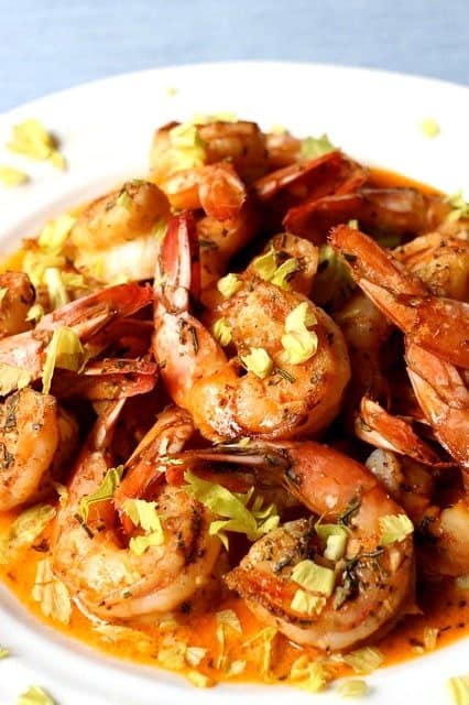 Spicy Drunken Shrimp on a platter with celery