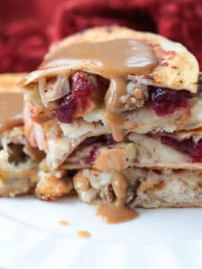 quesadillas stacked on a plate with gravy