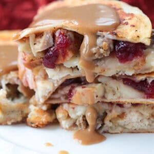 quesadillas stacked on a plate with gravy