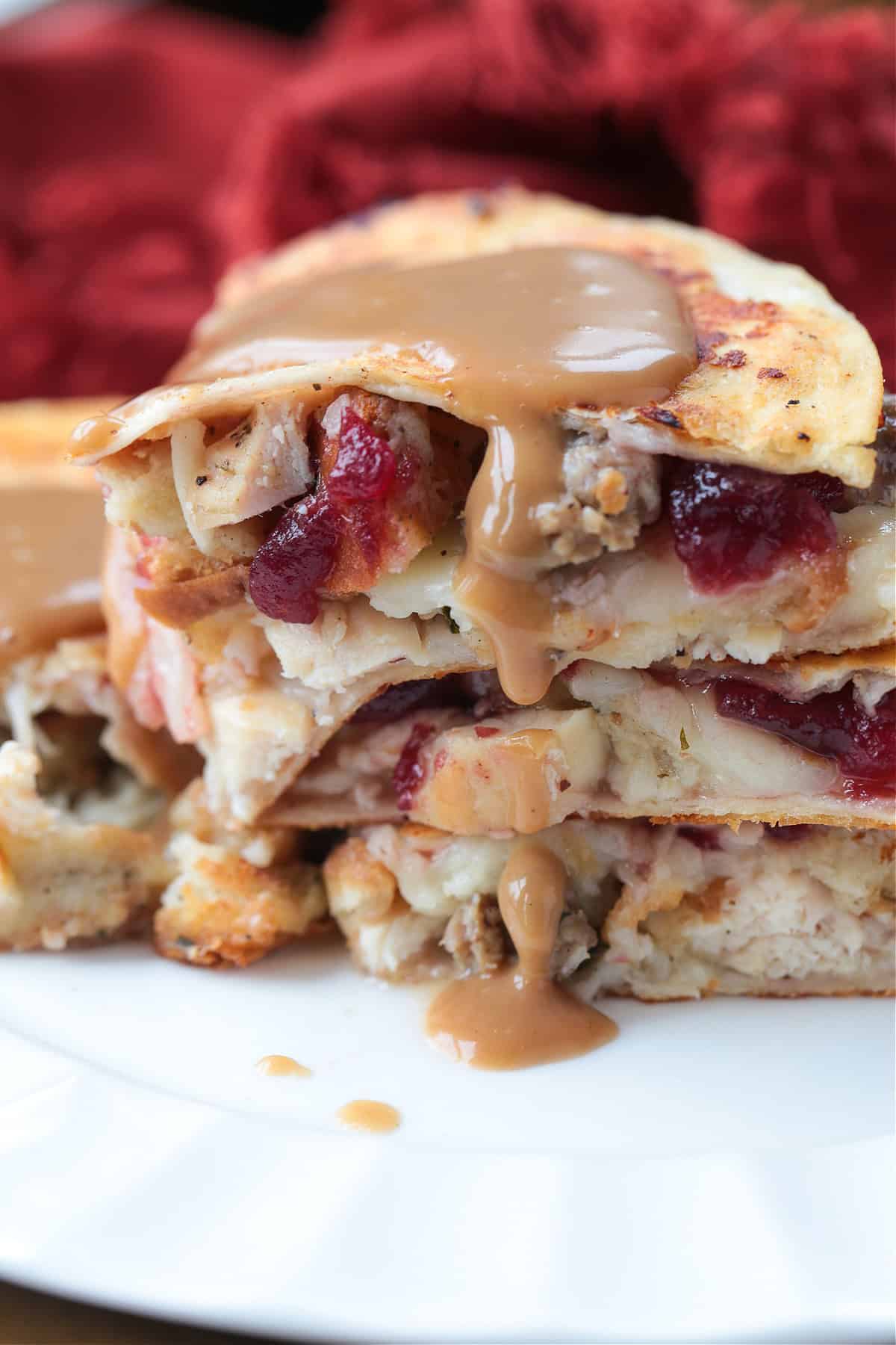 quesadillas stacked on a plate with gravy