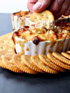 cracker dipping into seafood dip