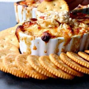 cracker dipping into seafood dip
