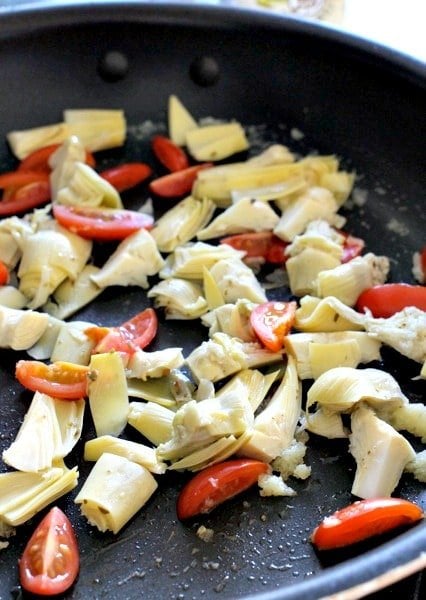 artichokes and tomatoes in skillet