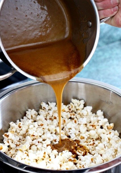 caramel sauce pouring onto popcorn