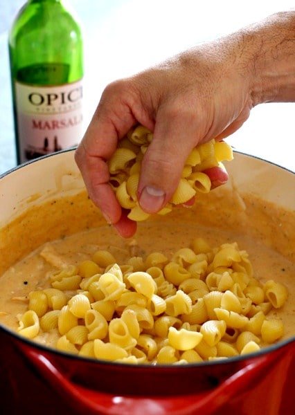 adding pasta to chicken marsala mac and cheese recipe