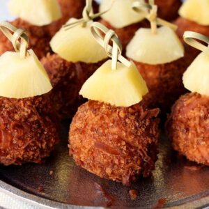 coconut chicken meatballs with pineapple garnish