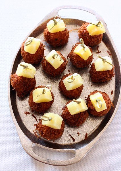 fried meatballs with pineapple garnish