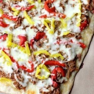 pizza topped with Italian beef, cheese and peppers