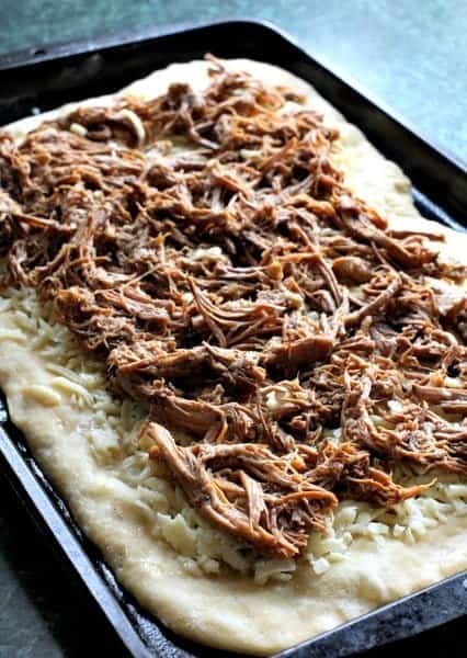 This Italian Beef Pizza has all the flavors of an Italian Beef Sandwich baked on a pizza! A fun recipe to serve at game days and parties! shredded beef on pizza crust