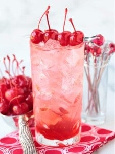 a dirty shirley cocktail with cherries on top