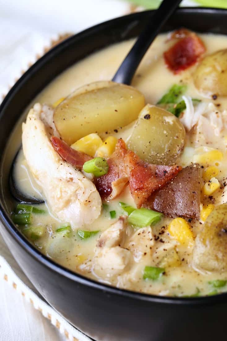 Chicken Chowder with corn and bacon with spoon in bowl